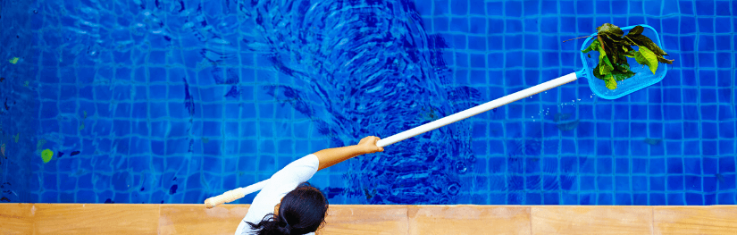 Woman cleaning swimming pool